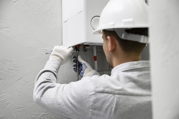 worker repairing boiler